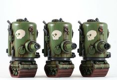 three green and white toy robots with skulls on them