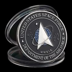 the united states space force emblem is shown on a coin that has been designed to look like an alien ship