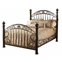 a metal bed frame with ornate designs on the headboard and foot board is shown