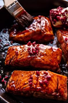 salmon and pomegranates cooking in a skillet