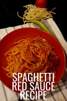 spaghetti with red sauce in a red bowl on a white and black checkered napkin