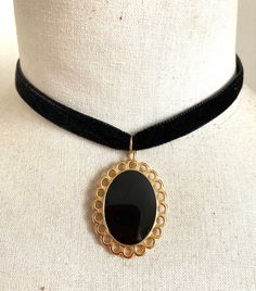 Black smooth velvet choker necklace (1cm wide). Oval gold-plated metal pendant (3.5cmx 2.5cm), black enameled center. Closed with a lobster clasp. Adjustment chain finished with a gold-plated metal drop. All metal parts are made of nickel-free zamac and made in Europe. Black Velvet Choker Necklace, Velvet Necklace, Velvet Choker Necklaces, Black Velvet Choker, Metal Drop, Velvet Choker, Black Choker, Black Necklace, Oval Pendant