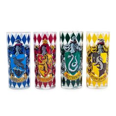 four harry potter glass tumblers are lined up in a row on a white background