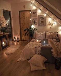 a bedroom with lights on the wall and a bed in the middle, surrounded by pillows