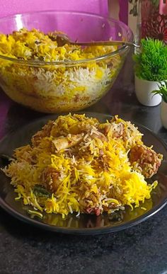 two bowls filled with food sitting on top of a table next to another bowl full of rice