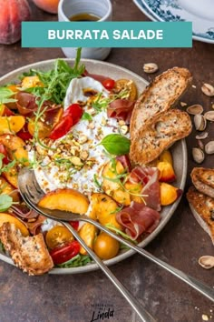 a plate with bread, salad and fruit on it