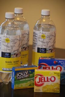 three bottles of water and two packets of yogurt are on the table next to each other