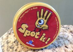 a round tin with the word spot it on it sitting on top of a marble counter