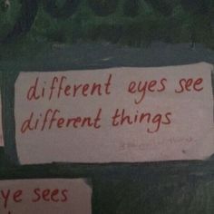 two signs on the wall that say different eyes see different things