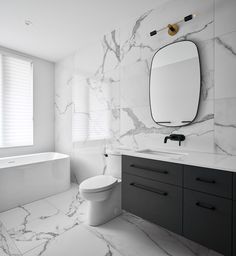 a bathroom with white marble walls and floors