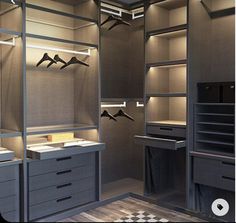 an empty walk in closet with drawers and lights