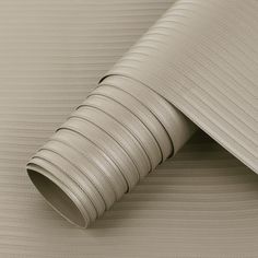 a close up view of a beige wallpaper with wavy lines on the side and bottom