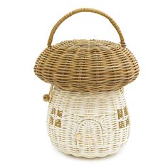 a white wicker basket with a handle on the front and bottom, sitting on a white background