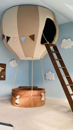 a large hot air balloon suspended from the ceiling in a child's play room