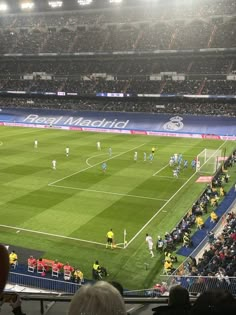 a group of people standing on top of a soccer field