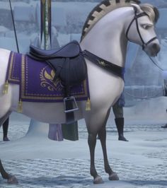 a white horse with purple and gold saddle standing in the snow