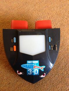 an electronic device with two red wheels on the front and one blue wheel on the back