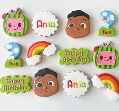 decorated cookies are arranged in the shape of children's faces and name on them