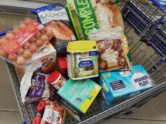 a shopping cart filled with food and condiments