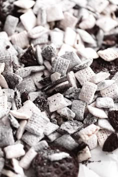 a pile of cookies and oreos sitting on top of a white tablecloth covered in dirt