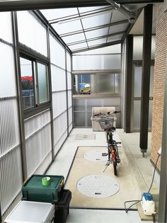 a bike is parked in the middle of a room with lots of windows and doors