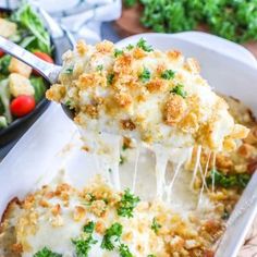 a casserole dish with cheese being lifted from it