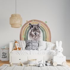 a room with a bed, pillows and stuffed animals on the floor