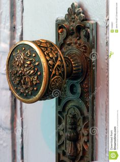 an ornate door handle on a wooden door