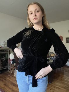 Beautiful black silk velvet blouse from the 1940s. Really beautiful draping, long sleeves, and has a wrap tie front. Fitted waist, otherwise blousy. Has a great bronze studded butterfly design at side of chest.  * Great condition, no flaws to note Shoulders: 16" Bust: 38" Waist: 27" Length: 22" Suggested sizing: small to smaller medium ---- All vintage items have been described and dated to the best of my ability. With this said, all dates are approximations unless there is specific documentatio Velvet Blouse, Velvet Blouses, Wrap Blouse, Style Expert, Silk Velvet, Butterfly Design, Black Silk, Womens Clothing Tops, Blouses For Women