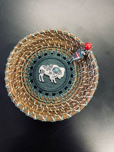 a woven basket with an elephant on it