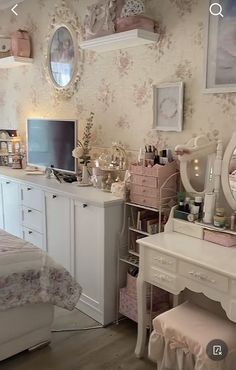 a bedroom with a desk, mirror and dresser in it