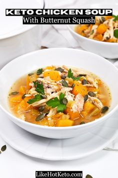 two white bowls filled with chicken and butternut squash soup on top of a table