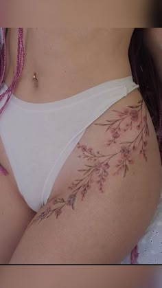 a close up of a woman's stomach with flowers on it