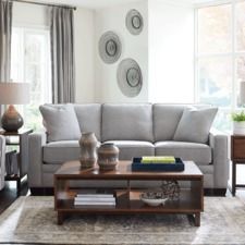 a living room scene with focus on the couch and coffee table in the center area