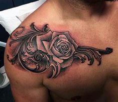 a man's chest with a rose tattoo design on the top half of his chest