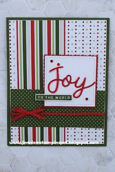 a christmas card with the word joy in red, green and white stripes on it