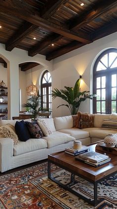 a living room filled with furniture and large windows