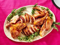 sliced chicken on a plate with parsley garnish