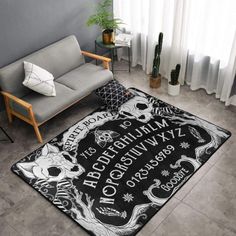 a living room area with a couch, chair and rug that has an image of skulls on it