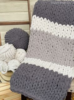 a crocheted blanket sitting on top of a wooden chair