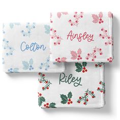 two white and red towels with holly designs on them, one has the word'ansley'printed on it