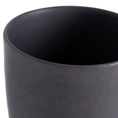 a close up of a black bowl on a white background