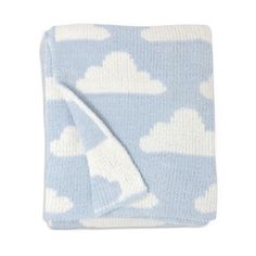 a blue blanket with white clouds on the top and bottom is folded up to show it's side