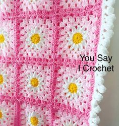 a pink crocheted blanket with yellow and white flowers on it, that says you say i crochet