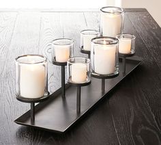 a tray with candles on it sitting on a table