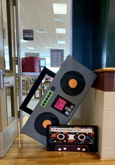 an old school tape recorder is stacked on top of each other in front of a door