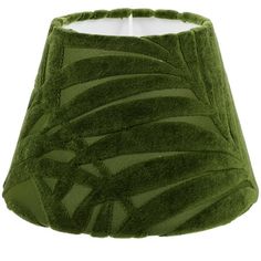 a green lamp shade that is made out of fabric and has palm leaves on it