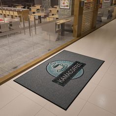 the entrance mat is on the floor in an empty restaurant