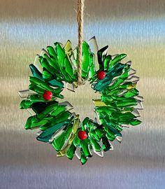 a green christmas wreath hanging from a rope