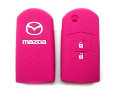 two pink key covers with mazda logo on them